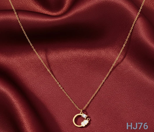 Delicate gold chain necklace with a small circular pendant framing a sparkling gem and a white cloud charm HJ76