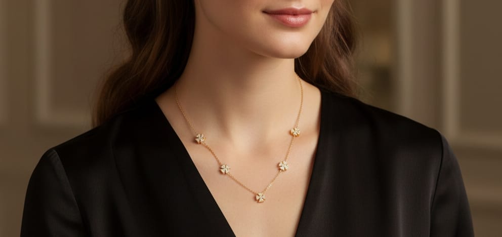 Gold station necklace with five evenly-spaced, diamond-studded, four-petal flower or cross-shaped motifs HJ77
