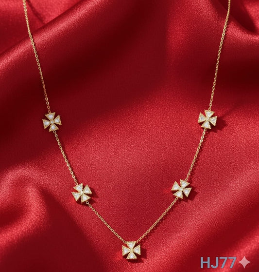 Gold station necklace with five evenly-spaced, diamond-studded, four-petal flower or cross-shaped motifs HJ77